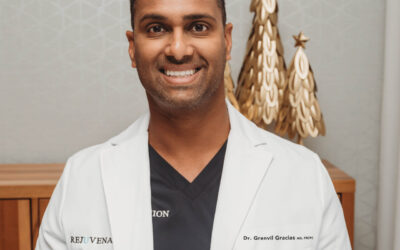 Dr. Gracias in a lab coat, smiling.